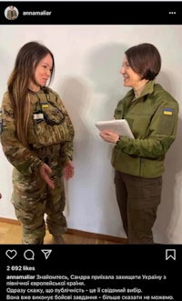 two women in military uniforms talking to each other