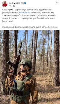 a woman with a gun in the woods